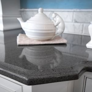 black quartz countertop with teapot on towel